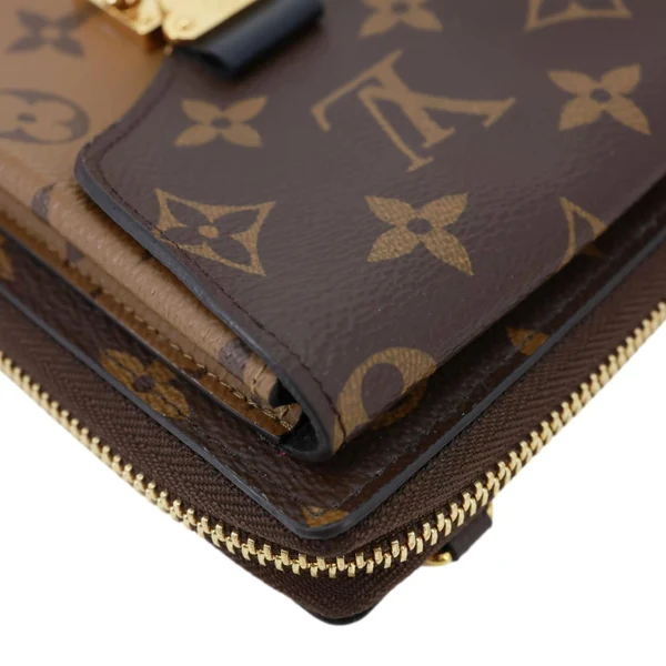 LOUIS VUITTON Metis Reverse Monogram Canvas Vertical Zippy Chain Wallet Brown